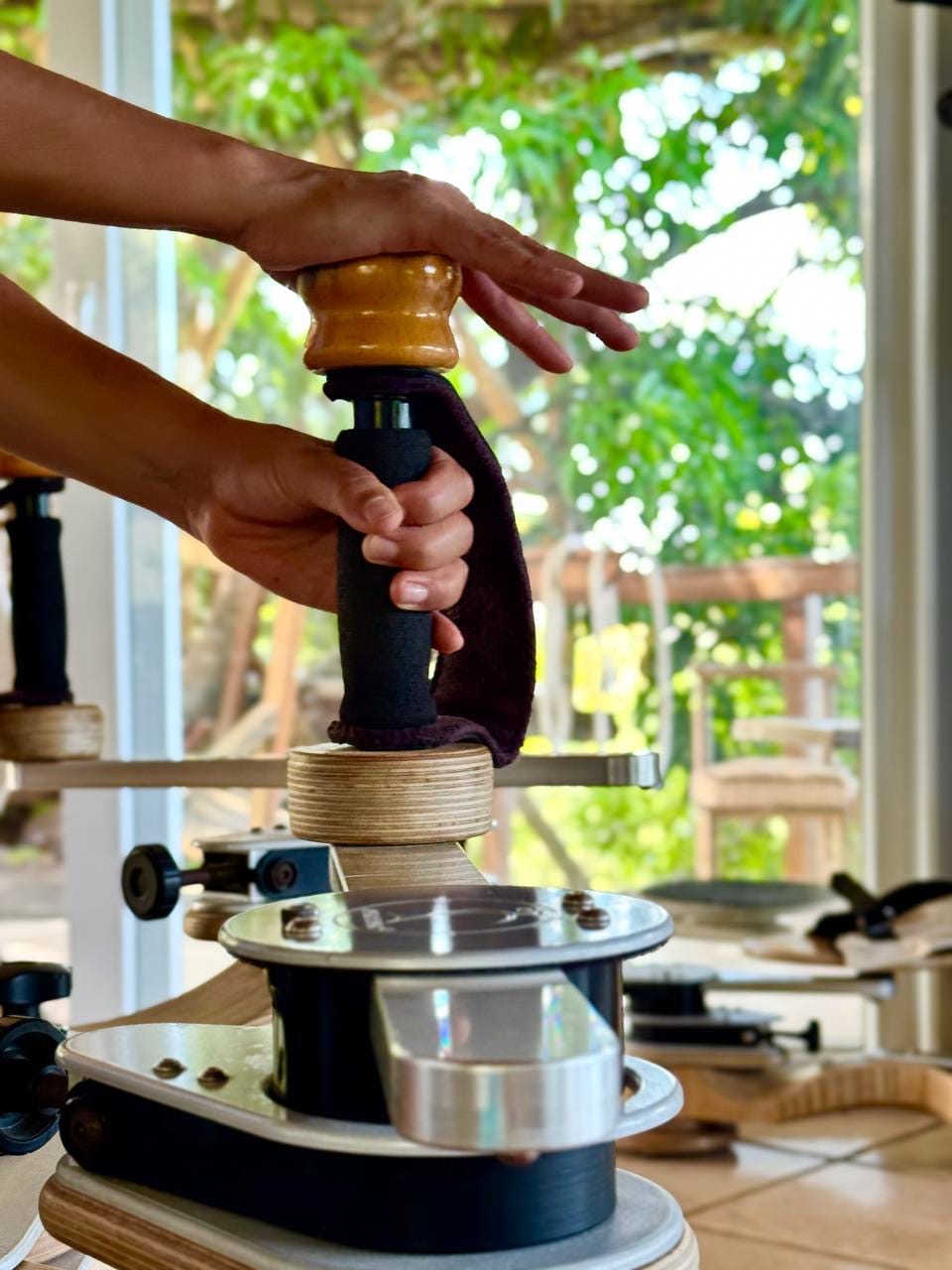 A trainer guiding a client on a Gyrotonic machine